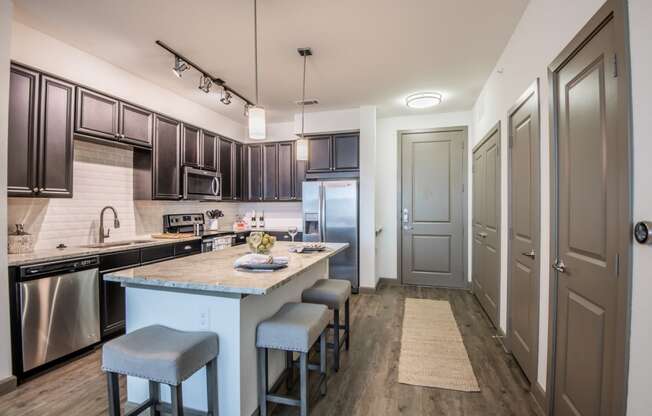 Modern Kitchen With Stainless Steel Appliances And Double Door Refrigerators at McKinney Village, Texas, 75069