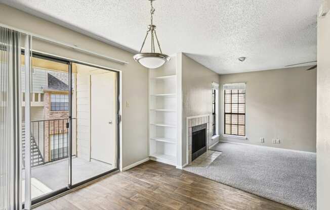 Living room connected to  a private patio with sliding glass door at Bandera Crossing apartments in San Antonio, TX