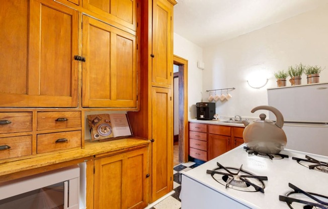 Kitchen with Wood Cabinetry and Vintage Style Decoration at The Park Apartments in Minneapolis, MN