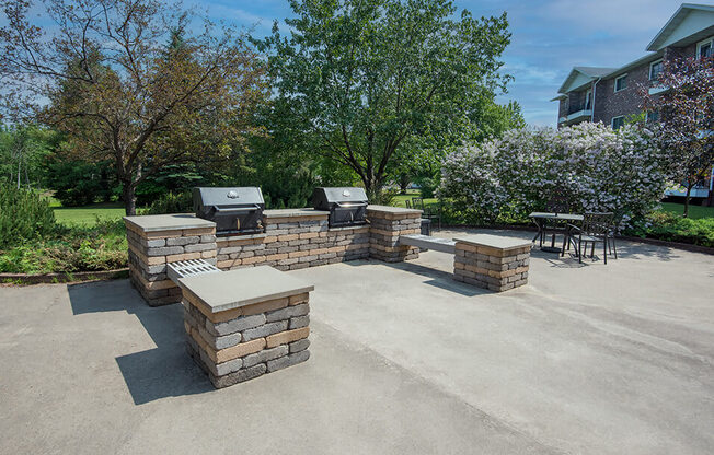 the backyard has a large patio with a grill and bbq area