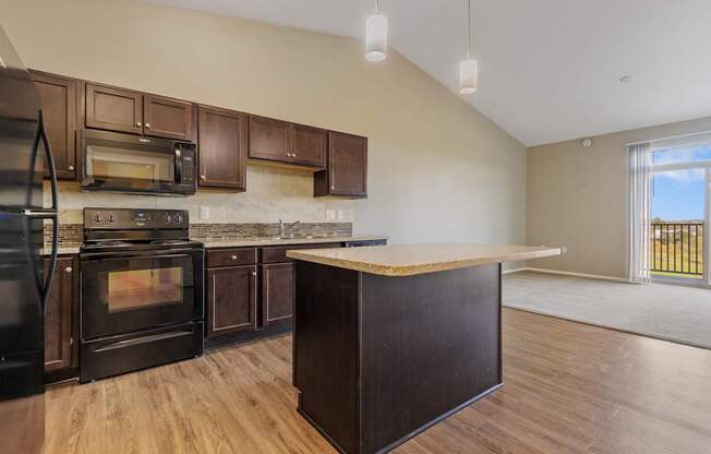 A kitchen with dark wood cabinets and appliances.