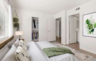 A bedroom with a large bed and a green blanket.