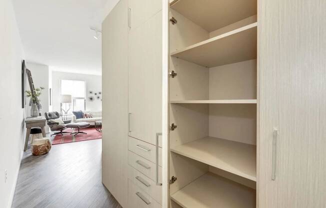 a large white closet with shelves in a living room