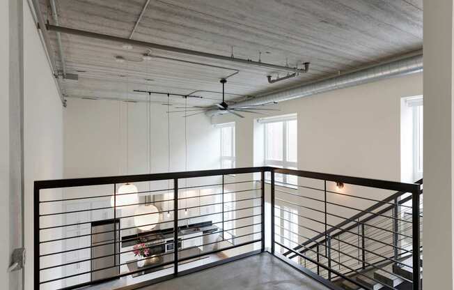 A large open space with a staircase and a balcony.