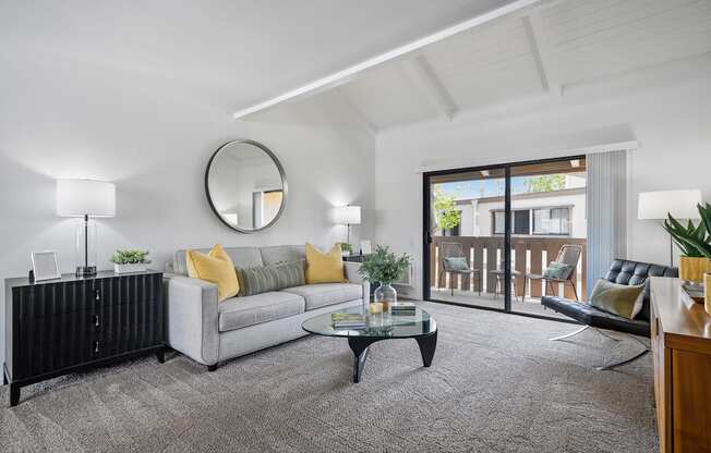 a living room with a couch and a glass coffee table