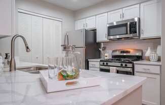 kitchen with stainless appliances and white cabinetry at The Residence at Christopher Wren apartments