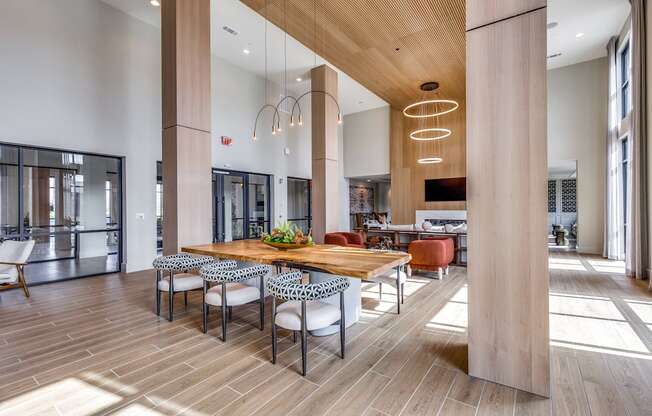 a large dining room with a wooden table and chairs