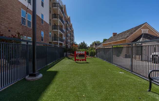 the yard is fenced in with a table and chairs on the grass