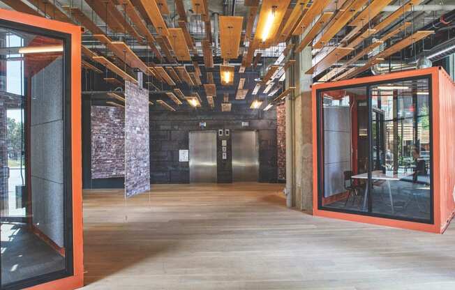 the lobby of a building with mirrors and glass doors