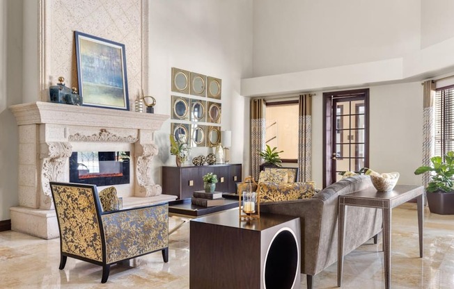 A living room with a fireplace, a chair, a table, and a painting on the wall.