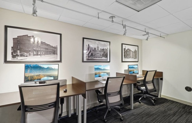 a conference room with desks and chairs and pictures on the wall
