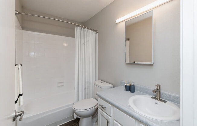 Model Bathroom with Wood-Style Flooring at Indigo Park Apartments in Albuquerque, NM.