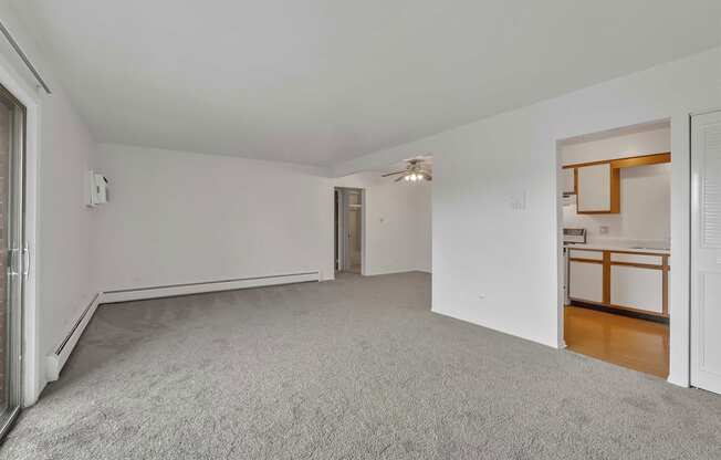 a bedroom with white walls and carpet