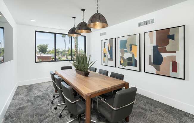 a conference room with a wooden table and black chairs