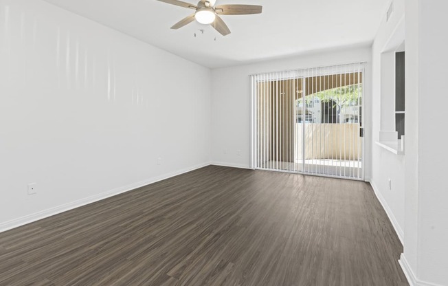 Living room with wood flooring and a ceiling fan at Solana Ridge, 92591