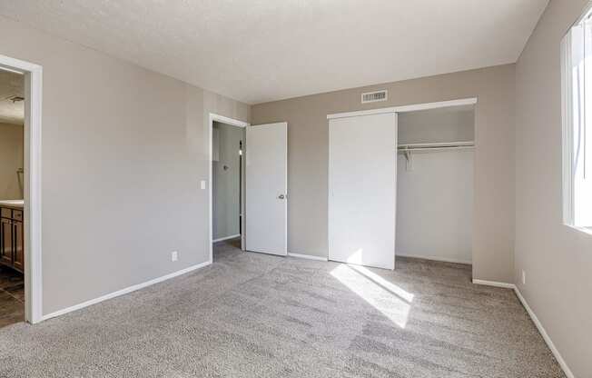 A room with carpeted floor and white walls. Omaha, NE Evergreen Terrace Apartments