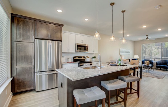 Southfield MI apartment- a kitchen with a large island with three stools