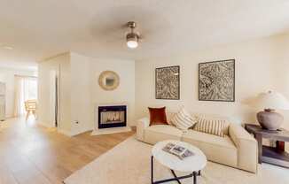 a living room with a couch and a fireplace