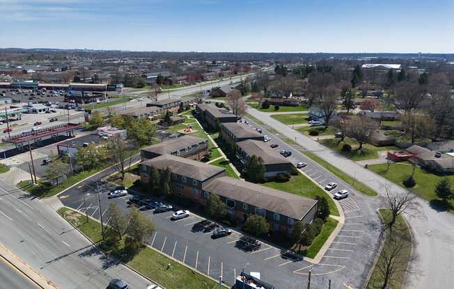 an aerial view of a neighborhood with houses and cars on the street