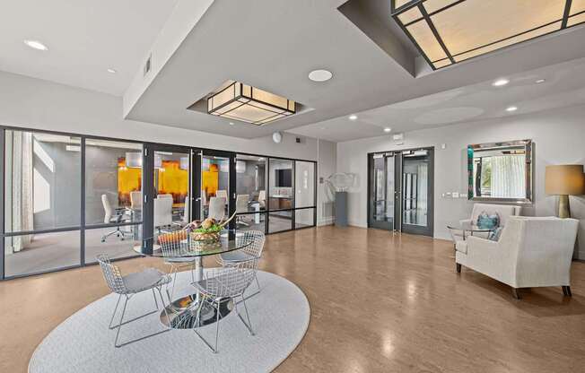 a living room with glass doors and a table and chairs