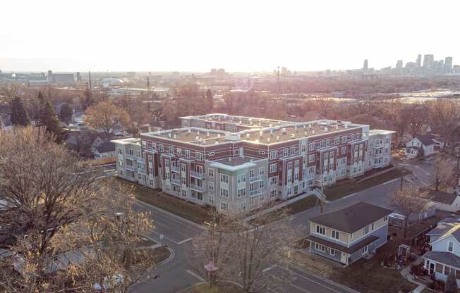 an aerial view of a large building with a city in the background