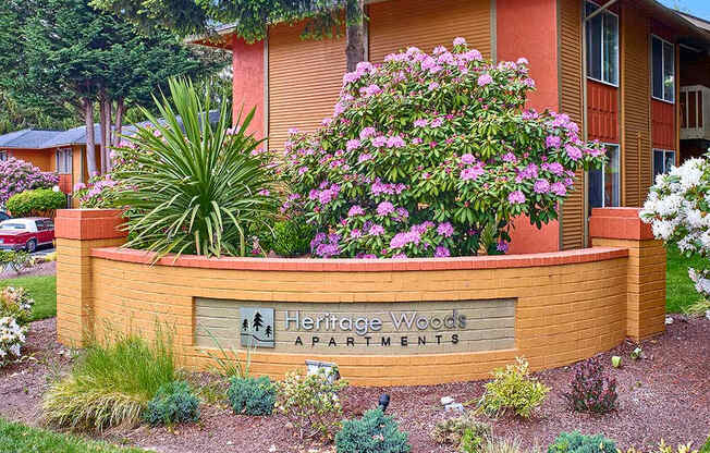 Heritage Woods sign with flowers around it