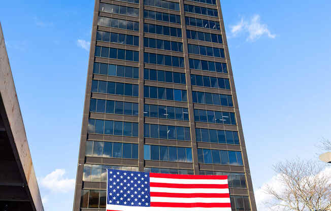 a large flag in front of a tall building