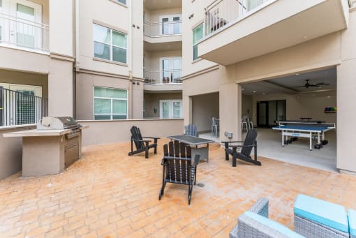 Patio with a ping pong table and chairs at Residences at 3000 Bardin Road, Grand Prairie