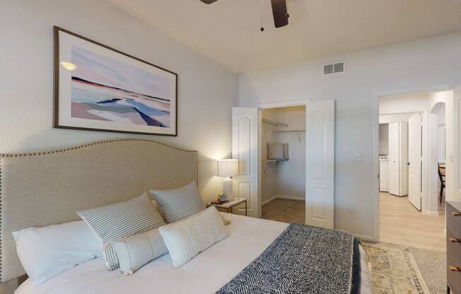 a bedroom with a bed and a ceiling fan