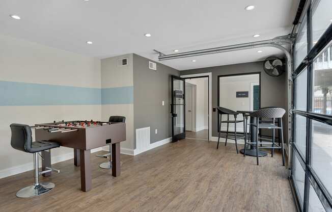 game room with a pool table and a bar area.