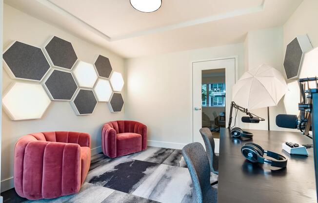 The podcast studio features professional recording equipment, acoustic treatments, and comfortable seating, providing residents with a dedicated space for content creation, recording, and virtual collaboration.