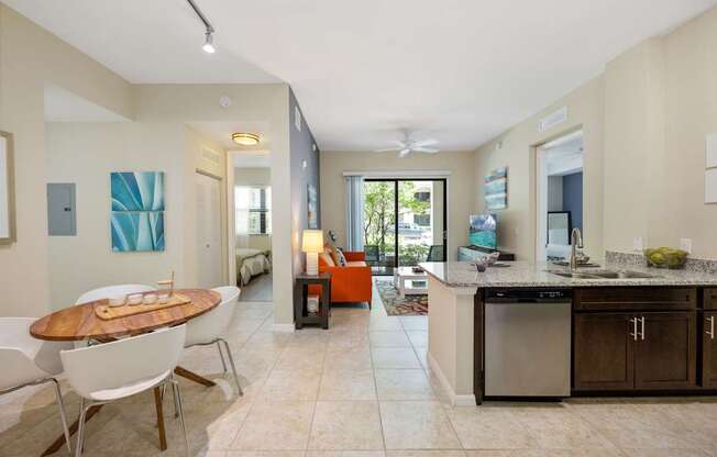 a living room and dining room with a table and chairs