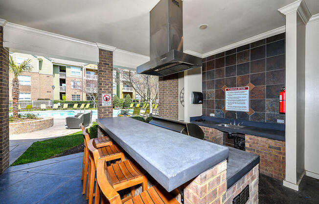 Outdoor Entertainment Space with Gas Grill and Bar Height Seating and Amble Counterspace at Alden Place at South Square Apartments, Durham, NC 27707