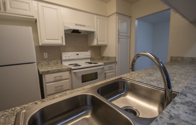 This is a photo of the kitchen of the 1084 square foot 2 bedroom townhome at The Biltmore Apartments in Dallas, TX.