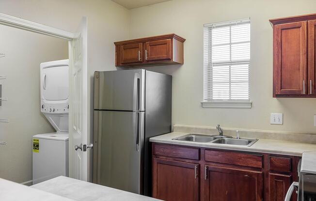 a kitchen with a sink and a refrigerator
