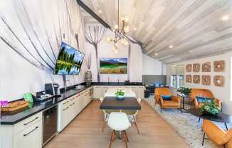 a dining room with a table and chairs and a kitchen and living room