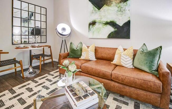 a living room with a brown couch and a table