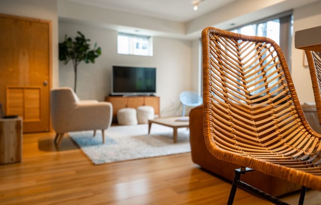 a living room with a wooden chair in front of a television
