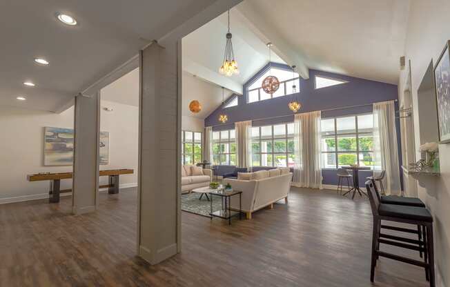 a living room with couches and chairs and a table