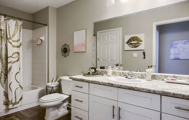 a bathroom with a white toilet next to a white sink