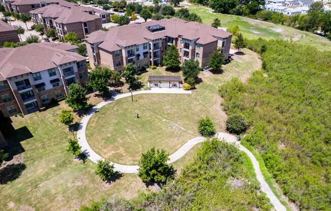 an aerial view of a building with a yard and a pathway at Discovery at Craig Ranch, Texas, 75070