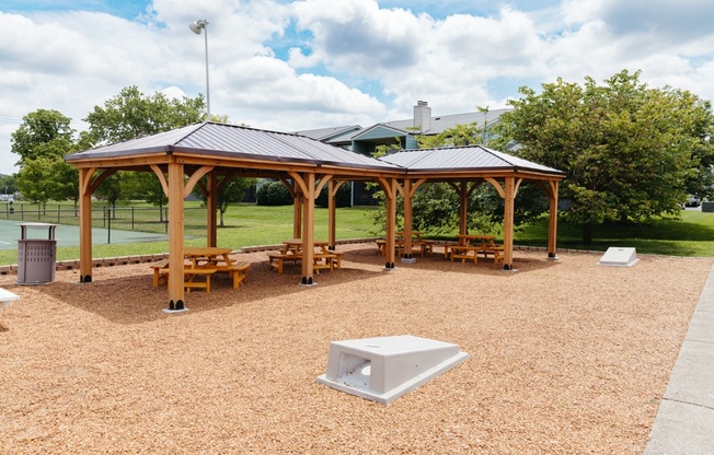 a picnic area with benches and a gazebo