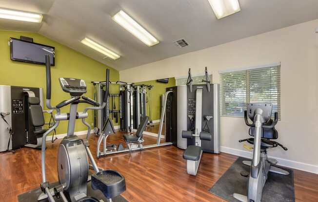 Fitness Center with Ellipticals, Weight Machines and Hardwood Inspired Floors at Monte Bello Apartments, Sacramento, CA