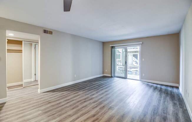 A room with a wooden floor and a ceiling fan.