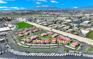 A large parking lot is in the foreground of a cityscape.