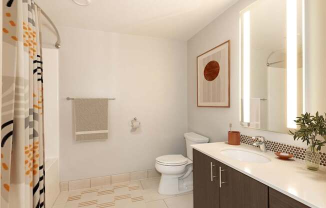 A bathroom with a toilet, sink, and shower.