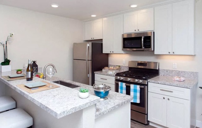 a kitchen with white cabinets and a counter top