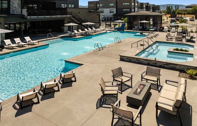 A large outdoor swimming pool surrounded by lounge chairs.