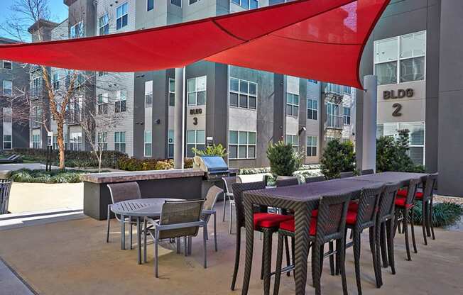 a view of a building from a patio with tables and chairs at Mockingbird Flats, Dallas, 75206