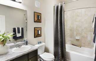 a bathroom with a shower toilet and sink and a bath tub